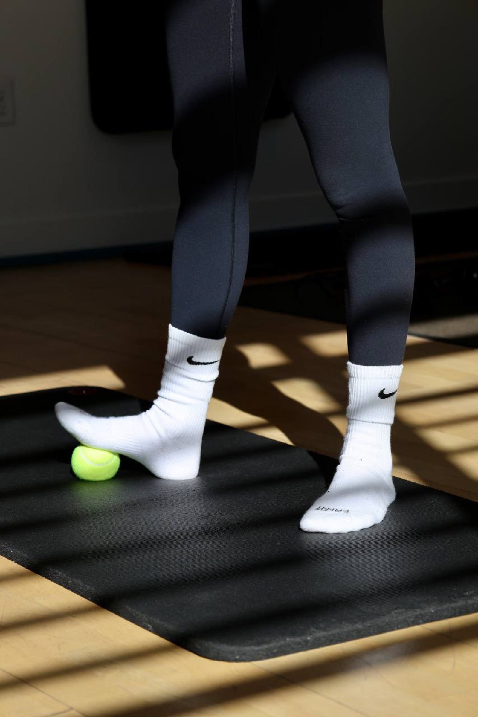 Close detail of foot-release work on a tennis ball during a session at Coach Ilona Studio
